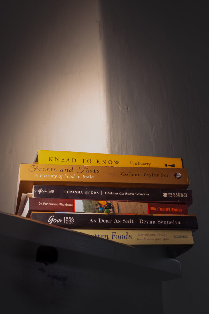 A curated stack of food books exploring culinary traditions, food history, and storytelling through recipes